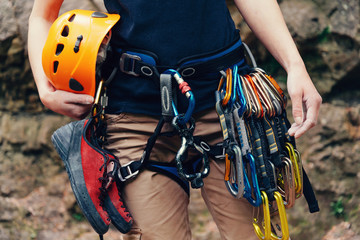 Woman standing with climbing equipment