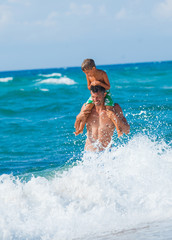 Poster - Father and son playing in the sea