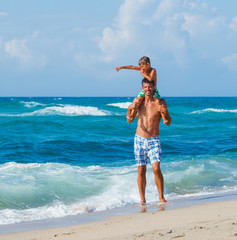 Wall Mural - Father and son playing in the sea