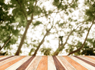 Poster - Empty perspective room with blurred green tree forest and wooden