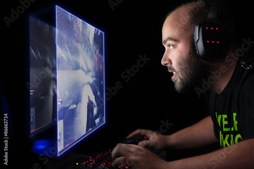 Plakat Gamer playing a first person shooter on high end pc.