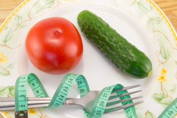 Cucumber and tomato with measuring