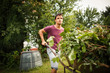 © lightpoet - Handsome young man gardening in his garden
