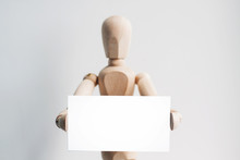 Wooden Mannequin With A Business Card. 