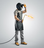 Fototapeta Zachód słońca - worker welder in a protective mask with gas welding machine