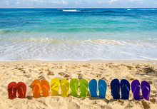 Colorful Flip Flops On The Sandy Beach