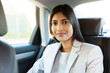 © michaeljung - young indian woman sitting inside a car