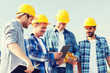 © Syda Productions - group of smiling builders with tablet pc outdoors