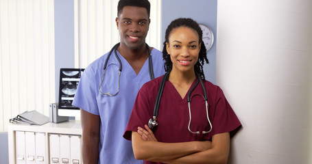 Portrait of two African American medical specialists standing in hospital