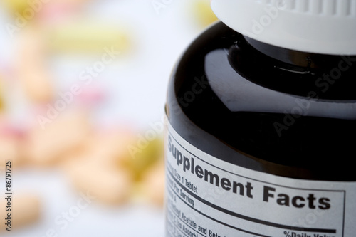 Fotografie, Obraz Vitamin Supplement Facts – A bottle of vitamins, with the supplement facts label showing