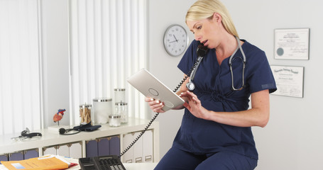 Pregnant nurse working in the office