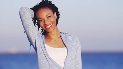 Wall Mural - African woman smiling and holding hair