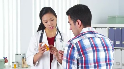 Wall Mural - Chinese doctor prescribing medication to patient