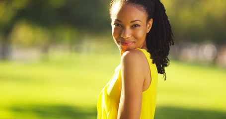 Black woman smiling in a field