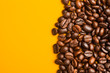 Roasted coffee beans close up. Yellow background. Space for text