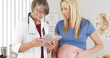 © rocketclips - Doctor talking to pregnant woman with tablet