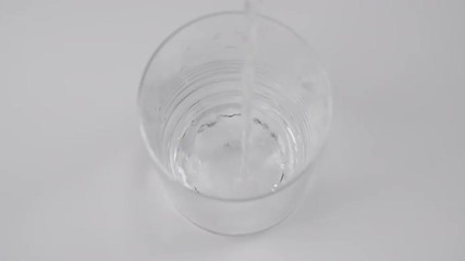 Sticker - filling glass with fresh water in slow motion