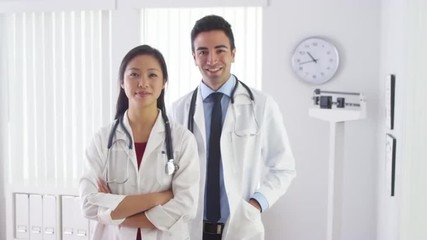 Wall Mural - Smiling doctors standing in office