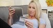 © rocketclips - Beautiful Pregnant woman buying baby supplies online