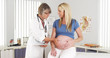 © rocketclips - Happy doctor touching pregnant woman's belly