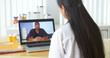© Mark Adams - Chinese doctor video chatting with African patient