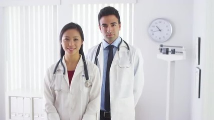 Wall Mural - Happy doctors standing in office