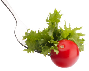 fresh salad and cherry tomato on fork isolated on white backgrou