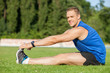 © Yakobchuk Olena - Attractive young male runner is warming up his body