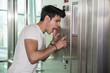 © theartofphoto - Scared young man desperate in stuck elevator