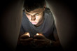 © theartofphoto - Teenage boy hiding while using a mobile phone