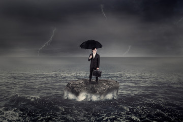 Worker standing on the sea over the rock