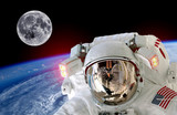 Fototapeta  - Astronaut spaceman isolated helmet space selfie earth moon. Elements of this image furnished by NASA.