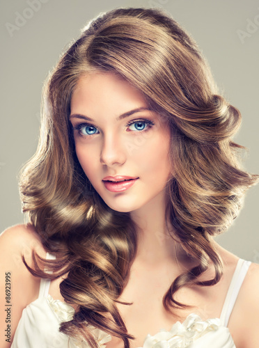 Naklejka na szafę Beautiful young girl with long hairstyle curly hair
