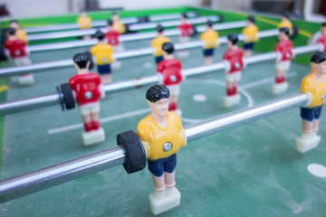 Table football game with yellow and red players