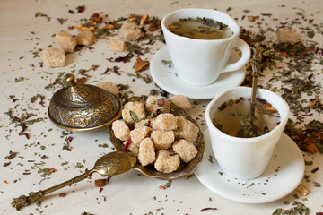 green tea in oriental style with brown sugar on a white marble