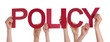 © Nelos - Many People Hands Holding Red Straight Word Policy