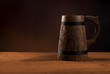 Mug of fresh beer on a wooden table.
