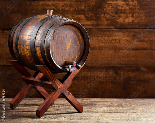 Fototapeta na wymiar wooden barrel on rustic wooden background