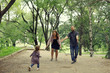 © kichigin19 - Mom and young daughter and dad, a young family on a walk in the park in summer