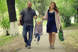 © kichigin19 - Mom and young daughter and dad, a young family on a walk in the park in summer