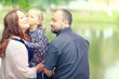 © kichigin19 - Mom and young daughter and dad, a young family on a walk in the park in summer