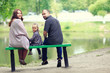 © kichigin19 - Mom and young daughter and dad, a young family on a walk in the park in summer