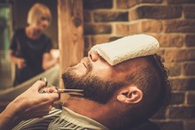 Client During Beard And Moustache Grooming In Barber Shop