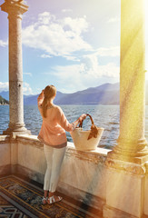 Canvas Print - Girl with a basket bag at the Como lake, Italy