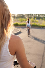 Wall Mural - Young woman on bicycle on road