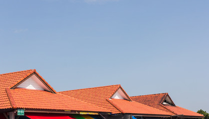 red rooftop against blue sky