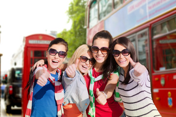 Canvas Print - happy teenage girls or women showing thumbs up