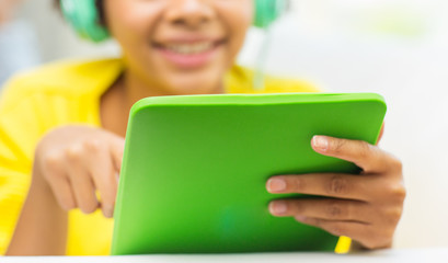 Poster - happy african woman with tablet pc and headphones