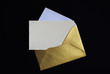 Opened golden envelope on black background