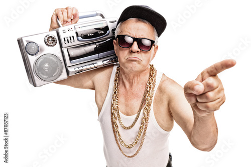 Fotografie, Obraz Senior rapper carrying a ghetto blaster on his shoulder
